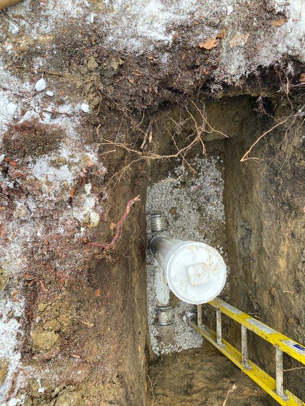 Completed excavation and installation of water service line with new meter housing. Installed vertical PVC standpipe with access cap to protect connection point. Properly backfilled trench with appropriate bedding material around pipe connections.