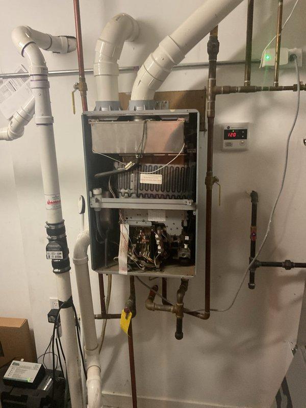 Diagnosed and repaired intermittent ignition failure on customer's tankless water heater. Inspection revealed buildup on ignition components and heat exchanger. Performed thorough cleaning of heat exchanger coils, ignition assembly, and control board connections, then tested system through multiple heating cycles to confirm proper operation at 126°F setpoint.