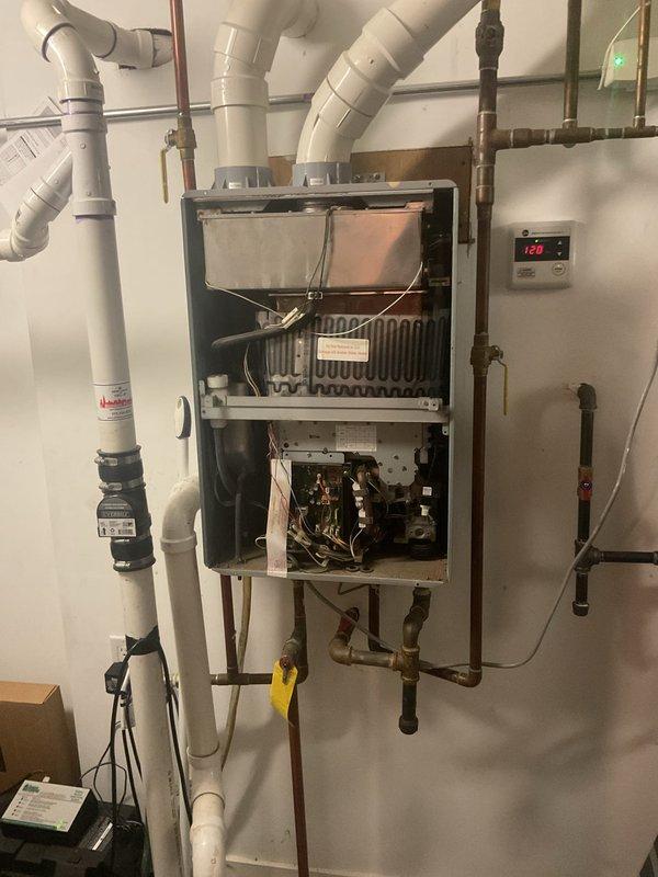 Diagnosed and repaired intermittent ignition failure on customer's tankless water heater. Inspection revealed buildup on ignition components and heat exchanger. Performed thorough cleaning of heat exchanger coils, ignition assembly, and control board connections, then tested system through multiple heating cycles to confirm proper operation at 126°F setpoint.