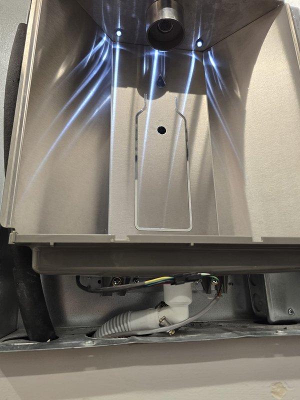 Performed inspection of wall-mounted water heater unit as sold by Lowden. Accessed internal components, documented condition of stainless steel chamber and electrical connections. Verified proper operation of control panel with digital display (reading 00012709) and confirmed LED indicator functionality.