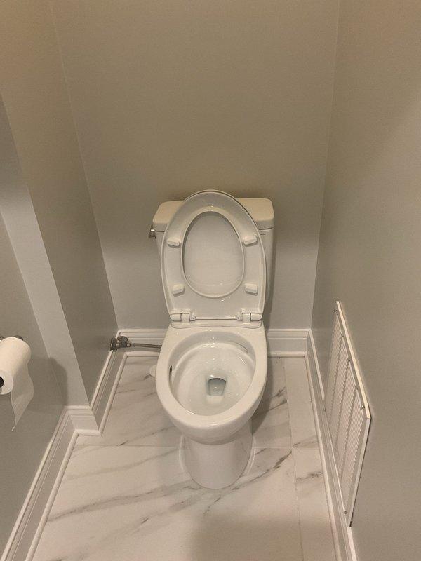 Responded to service call from Nick B. Inspected tankless water heater system with circulation pump and associated plumbing components. Verified proper installation of PVC venting and electrical connections. Also examined bathroom toilet for reported issues; no visible damage observed.