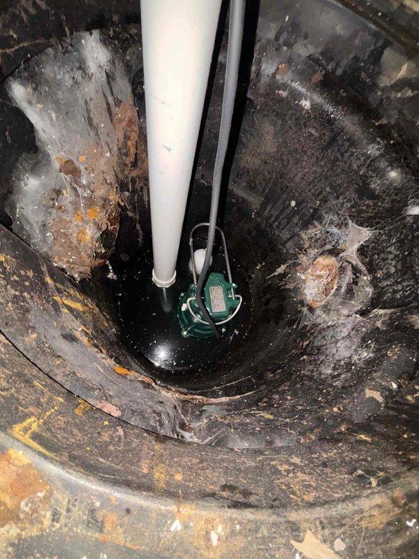 Completed ejector pump replacement in basement. Removed existing unit which showed significant sediment buildup, mineral deposits, and corrosion. Installed new submersible pump with proper electrical connections and verified system operation. Basin was cleaned of accumulated debris and rust deposits to ensure optimal performance.