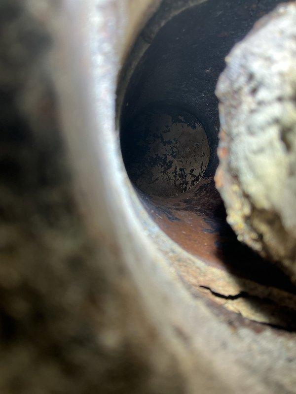 Performed inspection of client's plumbing system, documenting multiple drain issues. Identified significant pipe corrosion with visible cracks, extensive rust formation, and mineral buildup causing drainage restrictions. Photos confirm advanced deterioration of pipe interiors requiring comprehensive drain repairs.