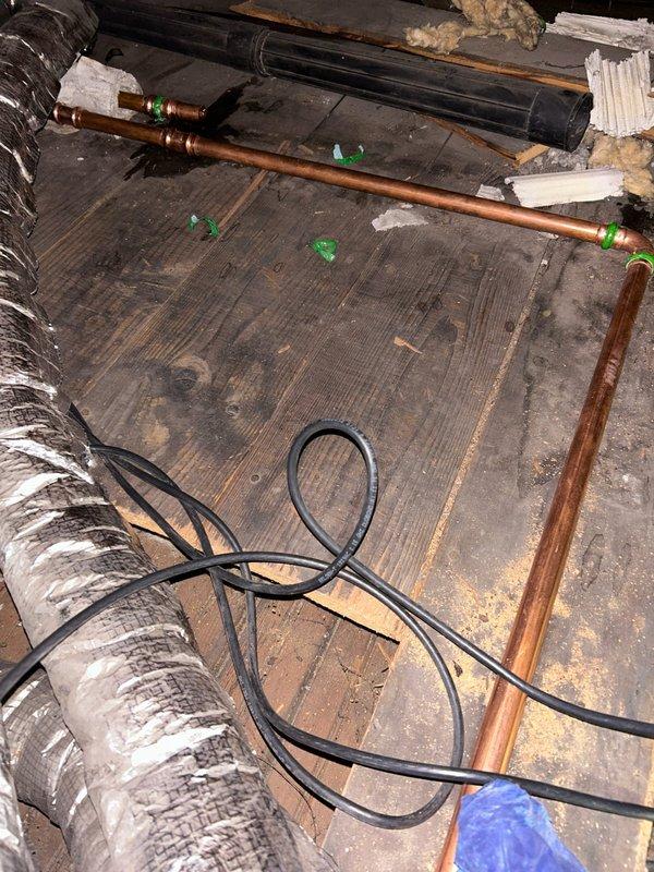 Inspected reported burst pipe issue affecting living room ceiling. Upon examination in the crawl space, found copper pipes with green connector joints running alongside HVAC ducting. Identified and repaired the leaking section of copper piping. No connection to boiler system as customer suspected. All plumbing now functioning properly with no active leaks observed.