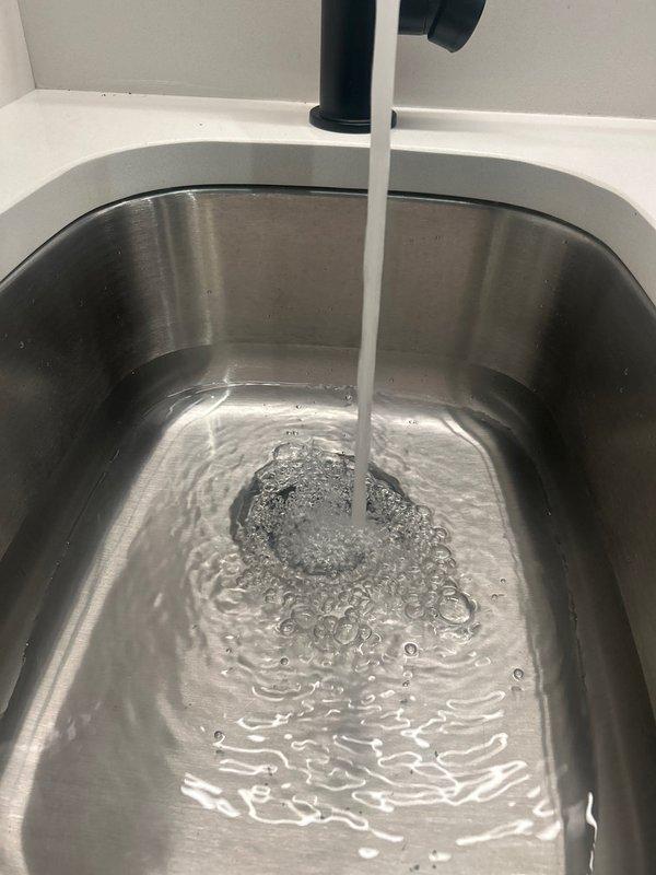 Responded to priority service call for a leaking butler's pantry sink. Diagnosed separation of sink seal on underside which customer had unsuccessfully attempted to repair with plumber's putty. Replaced damaged seal and reassembled drain assembly with proper sealing technique. Performed water test with running faucet to verify complete resolution of leak.