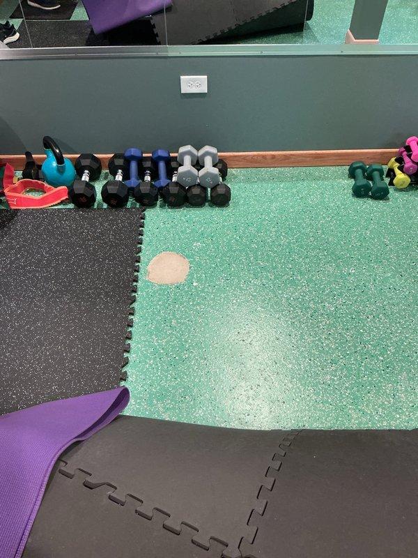 Responded to service call regarding previously capped catch basin with water seepage through concrete. Inspected the installation area in the fitness room with interlocking exercise flooring. Examined the square opening in concrete floor containing water meter and PVC piping system. No further remediation required as system functioning properly after inspection.