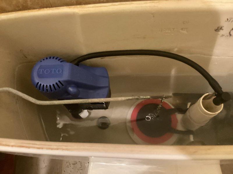 Responded to customer complaint of continuously running toilet. Inspected TOTO flush valve assembly and found worn flapper valve causing water to leak into bowl. Replaced flapper valve and adjusted water level to manufacturer specifications, resolving the running toilet issue. Customer's reported dishwasher leak was documented but not addressed during this service call.
