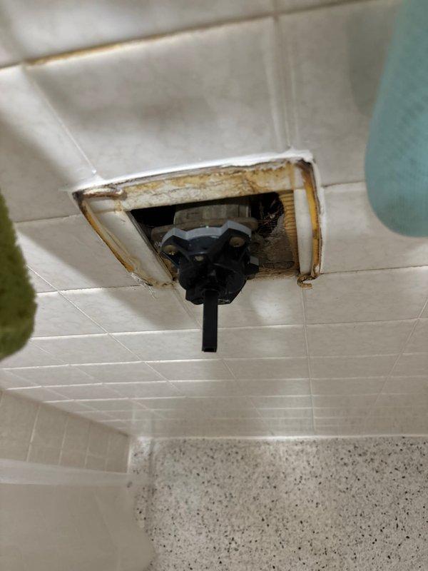 Completed replacement of damaged recessed valve assembly in bathroom tile wall which showed significant water damage and deterioration. Additionally, replaced malfunctioning bathroom exhaust fan that exhibited extensive mold growth and moisture damage around housing, improving ventilation and addressing potential moisture issues.