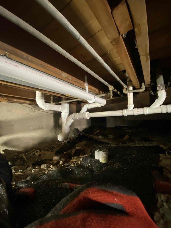 Successfully installed a new main line drain and sewer system in the crawl space, including proper installation of PVC piping along wooden joists with appropriate slope for drainage. System features multiple connection points and a clean-out access point for future maintenance, all completed as sold by Jon with no down payment required.