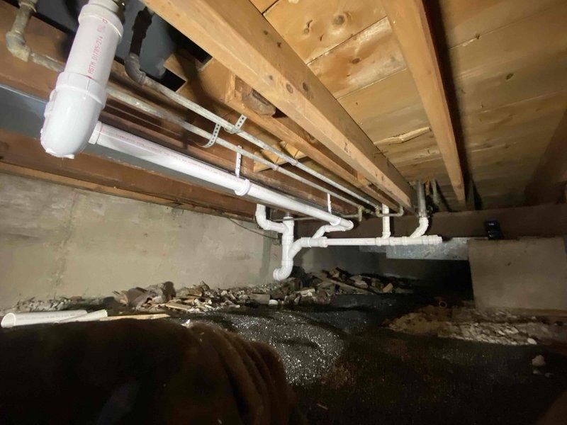 Successfully installed a new main line drain and sewer system in the crawl space, including proper installation of PVC piping along wooden joists with appropriate slope for drainage. System features multiple connection points and a clean-out access point for future maintenance, all completed as sold by Jon with no down payment required.