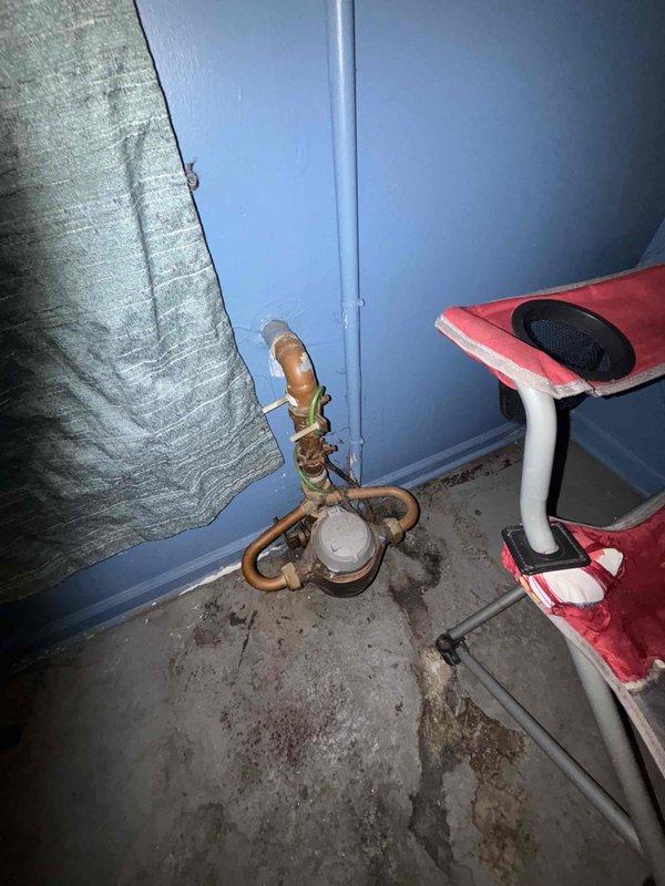 Conducted an inspection of a malfunctioning water heater in an unfinished basement after customer reported no hot water. Observed significant corrosion on copper pipe configuration and valve components with visible water damage on the concrete floor below, indicating active leakage. Provided customer with replacement options for the aging unit, noting the current installation would require updating to meet current code requirements.