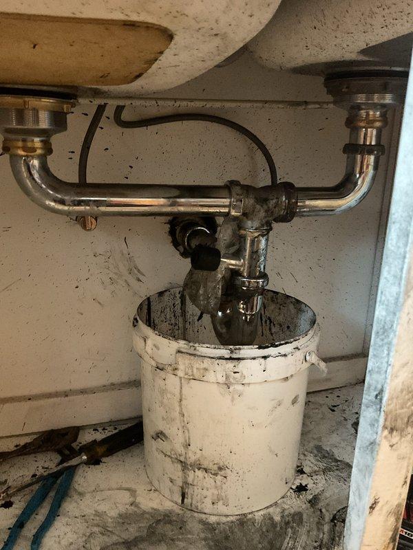 Responded to service call for kitchen sink clog in residential unit. Upon inspection, discovered blockage in P-trap drain system with signs of wear and minor corrosion on metal pipes. Successfully cleared obstruction and verified proper drainage function.