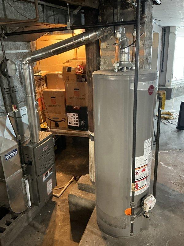 Conducted comprehensive assessment of residential plumbing system exhibiting mixed galvanized and copper piping with low water pressure issues. Inspected basement utility area containing water heater, HVAC equipment, and visible pipe network. Documented current installation to provide homeowner with repiping quote as requested.