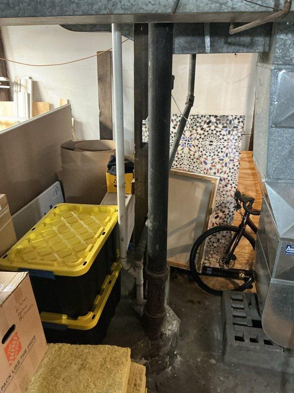 Conducted comprehensive assessment of residential plumbing system exhibiting mixed galvanized and copper piping with low water pressure issues. Inspected basement utility area containing water heater, HVAC equipment, and visible pipe network. Documented current installation to provide homeowner with repiping quote as requested.