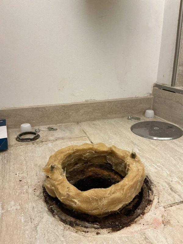 Arrived early morning during scheduled building shutdown to perform toilet installation. Removed old wax ring and prepared floor flange for new toilet mounting. Installed new wax seal and properly secured fixture to floor using appropriate mounting hardware and metal rings. Job completed with all connections properly sealed and tested.