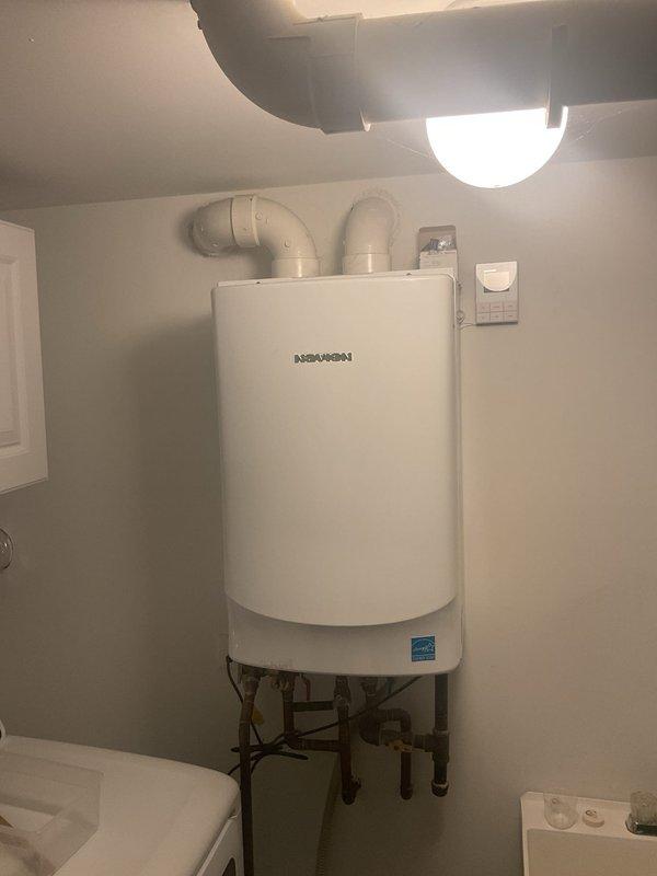 Diagnosed and serviced Navien tankless water heater that was only heating water to lukewarm temperatures, an issue reported to have started approximately two weeks ago. Performed comprehensive inspection of unit, including examination of ventilation system with PVC pipes and connections to home plumbing. After service, unit restored to proper functioning with appropriate hot water temperature output.