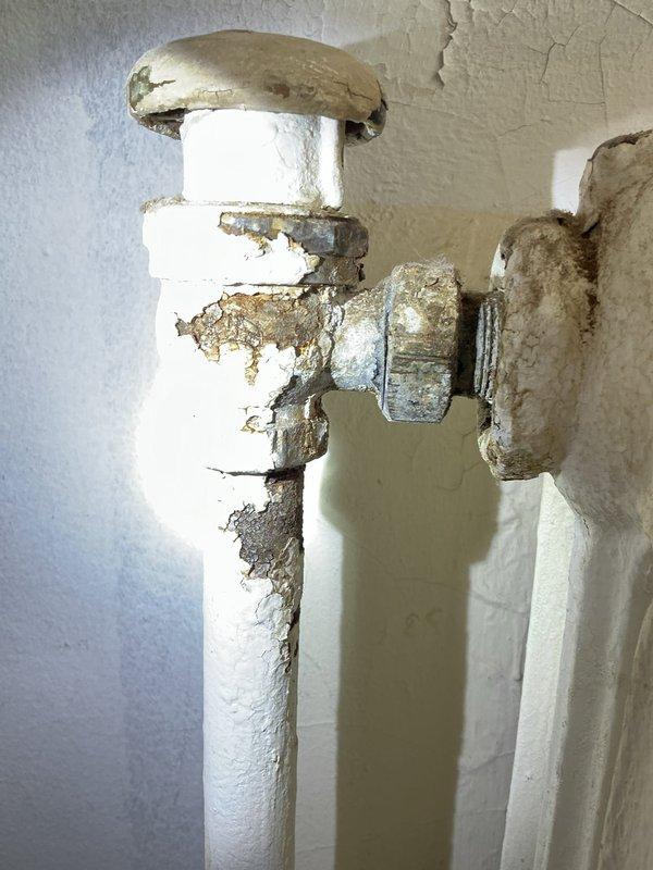 Responded to priority rescheduled service call to address severely deteriorated plumbing fixture. Upon inspection, found significant corrosion and water damage on wall-mounted valve assembly with compromised pipe connections. Replaced damaged valve fixture and restored proper functionality to the system.