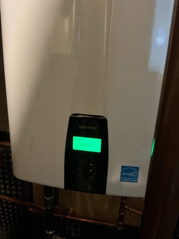 Responded to emergency service call for recently installed Navien water heater that had stopped functioning. Upon inspection, verified proper electrical connections at junction box and confirmed unit was receiving power. Reset control panel and restored normal operation, with temperature successfully maintaining at 128°F. All plumbing connections were checked for leaks and found to be secure.