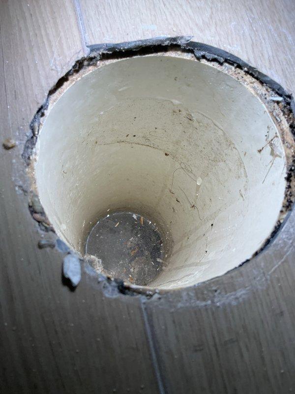 Responded to emergency service call for water on floor around laundry area. Inspection revealed deteriorated sump pump discharge pipe with visible cracking, debris accumulation, and inadequate sealing causing water backup. Replaced damaged PVC discharge pipe, properly sealed connection points, and restored proper drainage function to prevent future water intrusion.