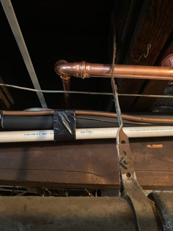 Installed new copper piping in basement utility area, including proper 90-degree elbow joints and secure bracket mounting. Connected system to existing PVC infrastructure and verified all connections for leaks. Parts provided by Joey.