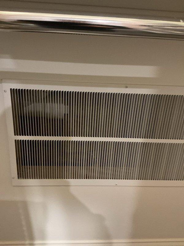 Investigated sewer odor complaint in laundry/powder room area. Client had attempted to flush drains without success in identifying source. Inspection revealed potential ventilation issues with air return grille and exterior drainage system. Observed outdoor drain with snow accumulation and possible moss/algae growth that may be contributing to the problem.