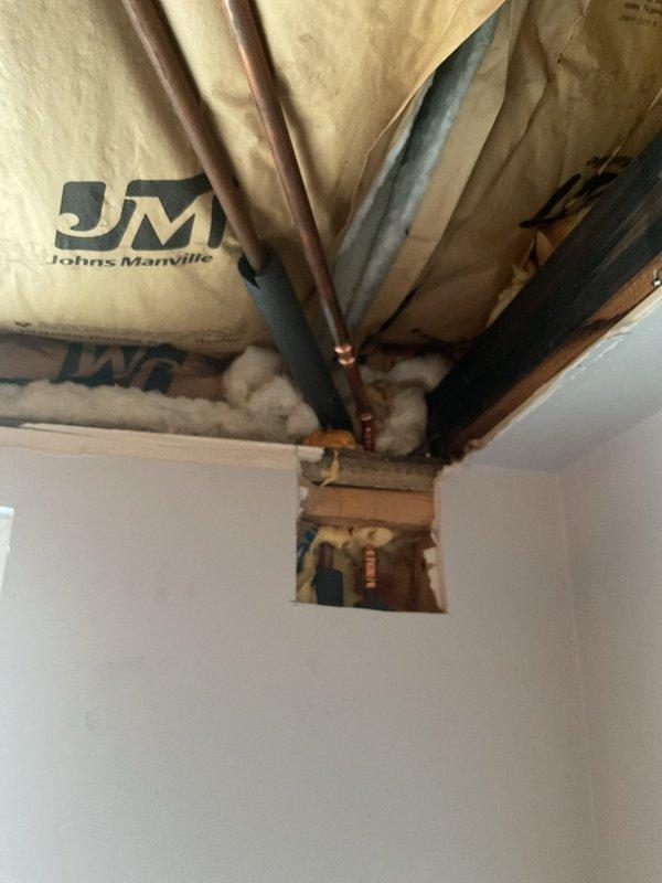 Responded to a VIP service call for a burst copper pipe in the laundry room ceiling. Upon inspection, found damaged copper supply line with insulation disturbed around the affected area. Accessed the ceiling through existing opening, replaced the damaged section of pipe, and restored proper insulation to prevent future freezing issues.