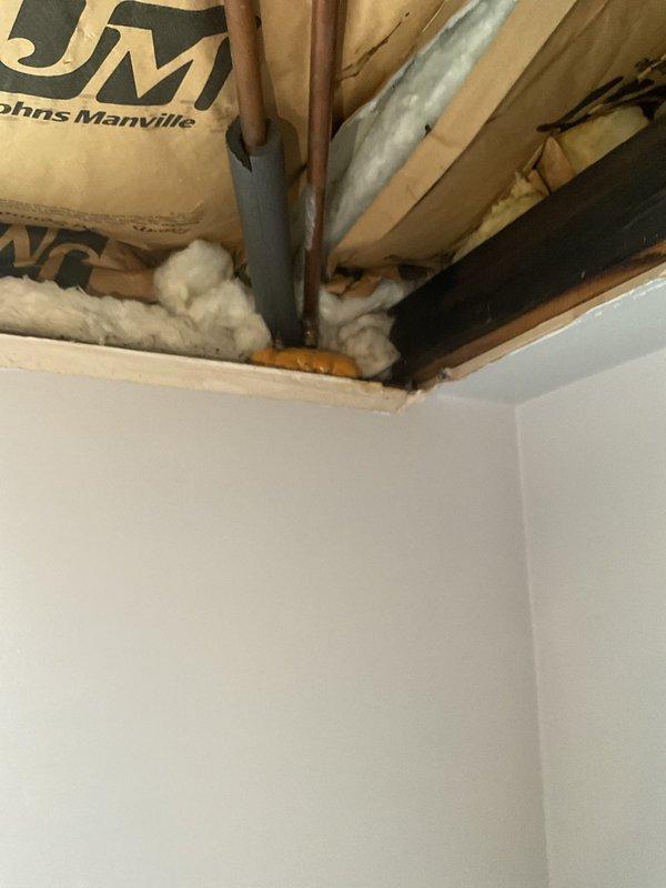 Responded to a VIP service call for a burst copper pipe in the laundry room ceiling. Upon inspection, found damaged copper supply line with insulation disturbed around the affected area. Accessed the ceiling through existing opening, replaced the damaged section of pipe, and restored proper insulation to prevent future freezing issues.