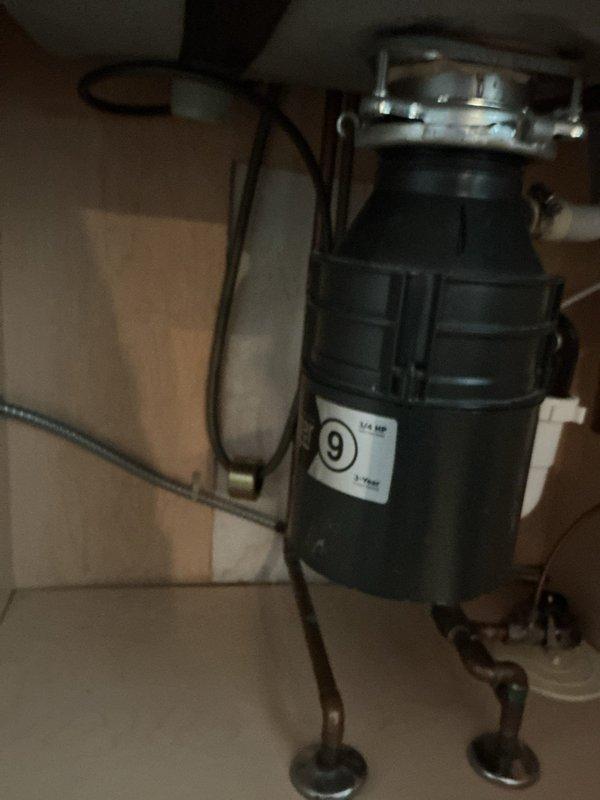 Responded to emergency service call for leaking faucet in kitchen. Upon inspection, found a modern chrome high-arch faucet with water leakage. Disassembled faucet assembly, replaced worn cartridge and gaskets, and verified proper operation of both main faucet and auxiliary dispenser. Also inspected 1/4 HP garbage disposal unit and surrounding plumbing connections to ensure no additional leaks were present in the system.
