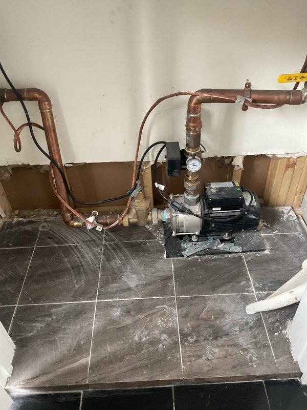 Conducted site visit to assess client's booster pump system. Inspected existing installation, which includes a black electric water pump mounted on the floor connected to copper piping network with pressure gauge. Photos taken of the setup for reference in preparing requested quote. Will coordinate with Anil to schedule follow-up appointment.