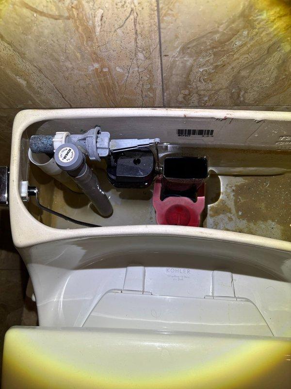 Responded to urgent service call for two slow-filling upstairs toilets. Inspected Kohler model K3386DA with suspected fill valve issues. Removed tank lids to examine internal components and found mineral buildup on the Kohler model 703 fill valves. Cleaned and adjusted the fill valve mechanisms to restore proper water flow and tank filling operation in both toilets.