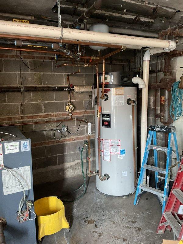 Responded to service call for non-functioning 100 gallon commercial Bradford White water heater resulting in no hot water. Upon inspection, determined replacement was necessary. Recommended and presented option for dual tankless water heater system with proper venting and connection to existing natural gas, hot water supply, and city water lines.