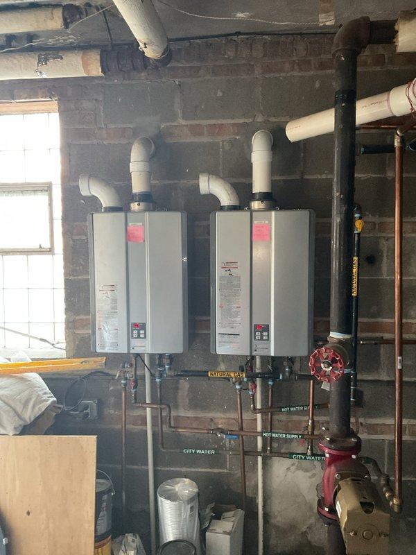 Responded to service call for non-functioning 100 gallon commercial Bradford White water heater resulting in no hot water. Upon inspection, determined replacement was necessary. Recommended and presented option for dual tankless water heater system with proper venting and connection to existing natural gas, hot water supply, and city water lines.