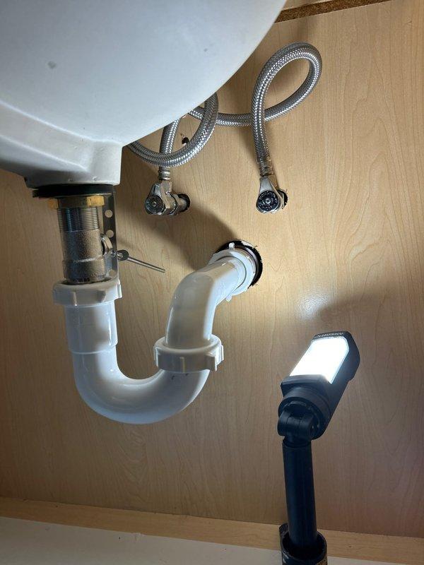 Completed installation of customer-provided faucet with new supply lines. Installed and secured P-trap drain assembly with proper connections. All components verified for proper fit and function with no leaks observed.