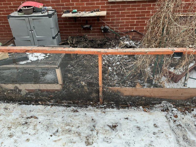 Conducted priority inspection of PVC drainage system in crawl space beneath wooden structure. Documented existing plumbing configuration including P-trap assembly and multiple pipe joints. Photographed exterior service area adjacent to foundation wall where plumbing exits structure through wooden enclosure for warranty documentation purposes.