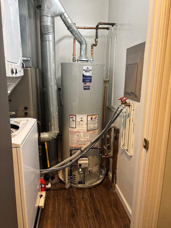 Successfully completed installation of a Bradford White tanked water heater in Unit #201, replacing the previous Prestige model. Installation included connecting copper intake/outflow pipes, attaching the metal ventilation duct, and ensuring proper valve connections with all necessary fittings. All systems were tested and confirmed operational upon completion.