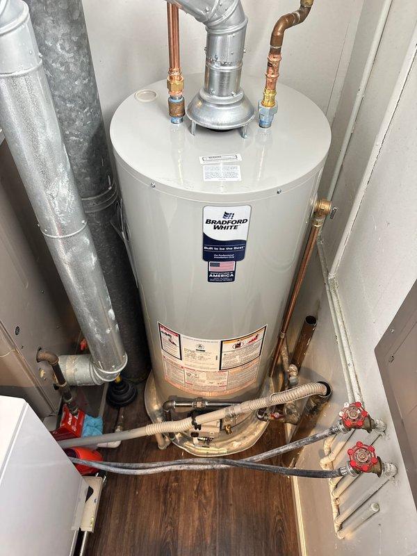 Successfully completed installation of a Bradford White tanked water heater in Unit #201, replacing the previous Prestige model. Installation included connecting copper intake/outflow pipes, attaching the metal ventilation duct, and ensuring proper valve connections with all necessary fittings. All systems were tested and confirmed operational upon completion.