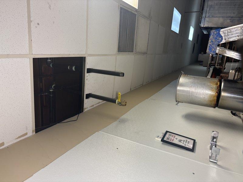 Completed inspection of mechanical room as sold by Joey. Identified missing ceiling tile in drop ceiling grid system near fluorescent light panel, which was showing signs of discoloration. Documented condition of exposed metal pipes, ductwork, and ventilation components with photographs for service record.