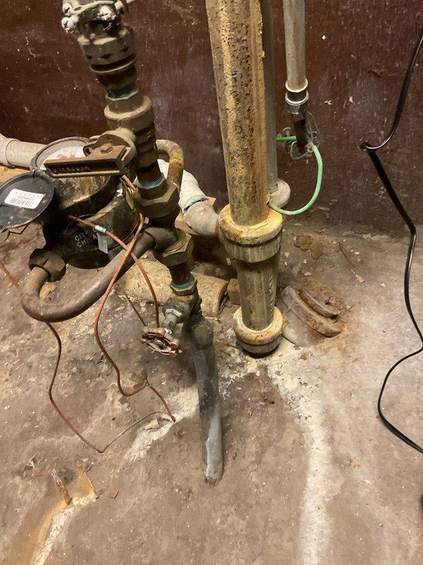 Responded to emergency service call for burst pipe. Discovered significant water leakage between buildings that had frozen into a substantial ice formation. Inspection revealed corroded copper pipe with failed joints in the utility area. Replaced damaged section of pipe, installed new fittings, and restored water service to the property.