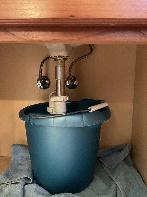 Responded to service call for a leaking bathroom faucet with automatic sensor. Upon inspection, discovered water actively leaking from the P-trap connection, requiring installation of a new P-trap assembly and tightening of all connection points. Tested system thoroughly after repair, confirming complete resolution of leak with no additional issues detected.