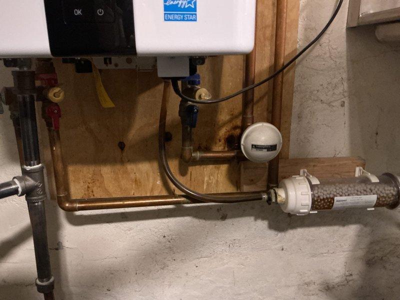 Responded to VIP customer's service call regarding a slow-draining bathtub. Cleared the clogged drain and performed a comprehensive whole-home plumbing inspection, documenting conditions in the basement/crawlspace area and examining the water heater installation. Noted potential previous moisture issues near the water heater and inspected the home's pipe system, which includes both PVC and older metal piping.