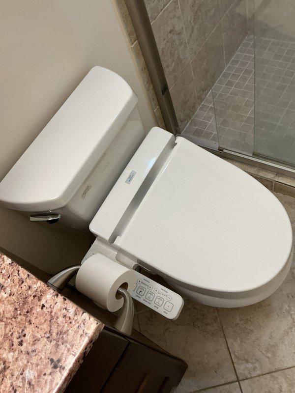 Inspected bathroom toilet for reported hairline fractures on porcelain surface. Documented existing stress cracks and minor discoloration on ceramic fixture. Customer requested specific technician exclusion for future service calls.