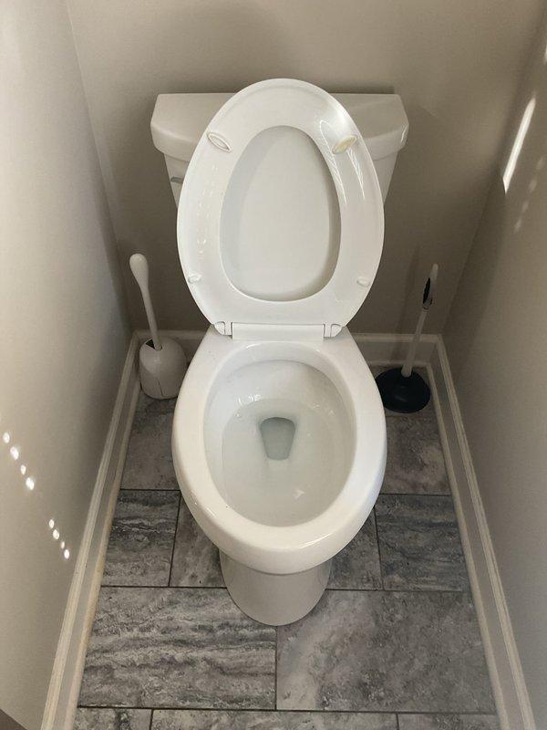 Responded to service call for toilet not flushing correctly and filling to rim. Removed existing toilet to access flange, which showed visible corrosion. Installed new wax ring and reset toilet after clearing drain line. Tested flushing operation to confirm proper water level and function.