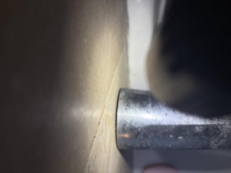 Conducted follow-up service on previously identified shower leak affecting unit below. Inspected shower handle assembly showing continued water seepage and visible moisture around pipe fittings. Evaluated bathroom plumbing connections including sink fixtures for potential contributing factors to the persistent leak issue.