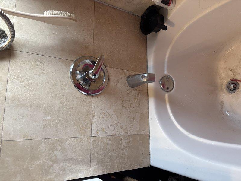 Conducted follow-up service on previously identified shower leak affecting unit below. Inspected shower handle assembly showing continued water seepage and visible moisture around pipe fittings. Evaluated bathroom plumbing connections including sink fixtures for potential contributing factors to the persistent leak issue.