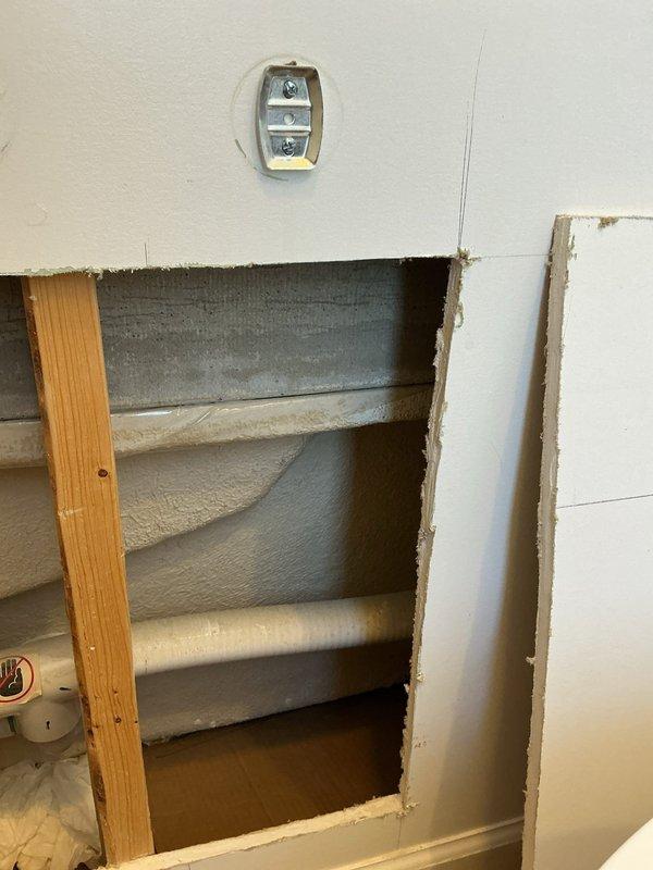 Investigated jacuzzi tub leak by accessing plumbing through wall cavity. Inspected copper supply lines and connections within wooden framed structure, noting oxidation on pipes. Located source of leak at connection point and repaired faulty fitting to restore proper function of tub.