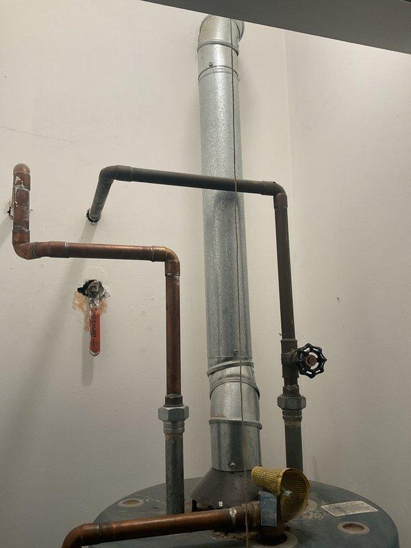 Responded to VIP service call for 40-year-old 40-gallon water heater leaking from tank bottom. Visual inspection confirmed tank failure with significant corrosion at base. Replaced unit with new code-compliant water heater, including installation of proper venting, copper supply lines, and shut-off valve. Verified operation and leak-free connections before completing service.