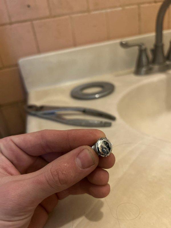 Completed shower valve service by removing and replacing damaged trim components. Extracted worn retainer ring from valve assembly. Job was originally sold by Jacob and documented with before/after photos of the repair.