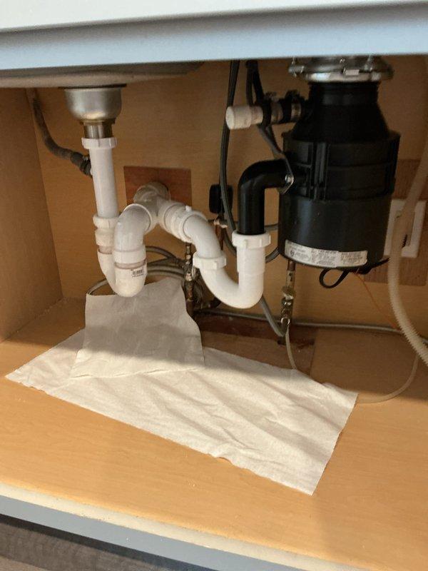 Installed new garbage disposal unit under kitchen sink, replacing existing system. Verified proper P-trap configuration and secured all PVC connections. Tested operation to confirm no leaks present at connection points.