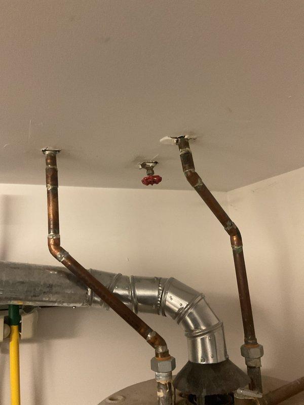 Assessed client's request to replace existing GE 50-gallon natural gas water heater (model PG50T9A) and install water softening/filtration systems. Inspected current installation, noting copper pipe configuration and existing water heater placement in utility room with proper drain pan. Provided recommendations for comparable replacement unit along with compatible water softening system and under-sink filtration options for the kitchen.