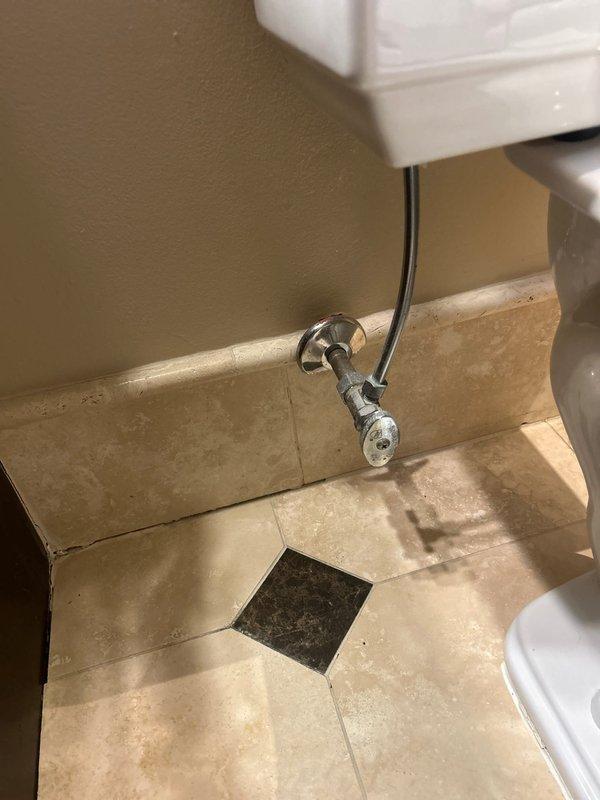 Completed toilet service involving removal of tank lid to access and repair the internal flush mechanism. Inspected water supply line, shutoff valve, and connection hose - all components in good working condition with no visible leaks or corrosion. Reinstalled tank lid and verified proper operation before completing service.